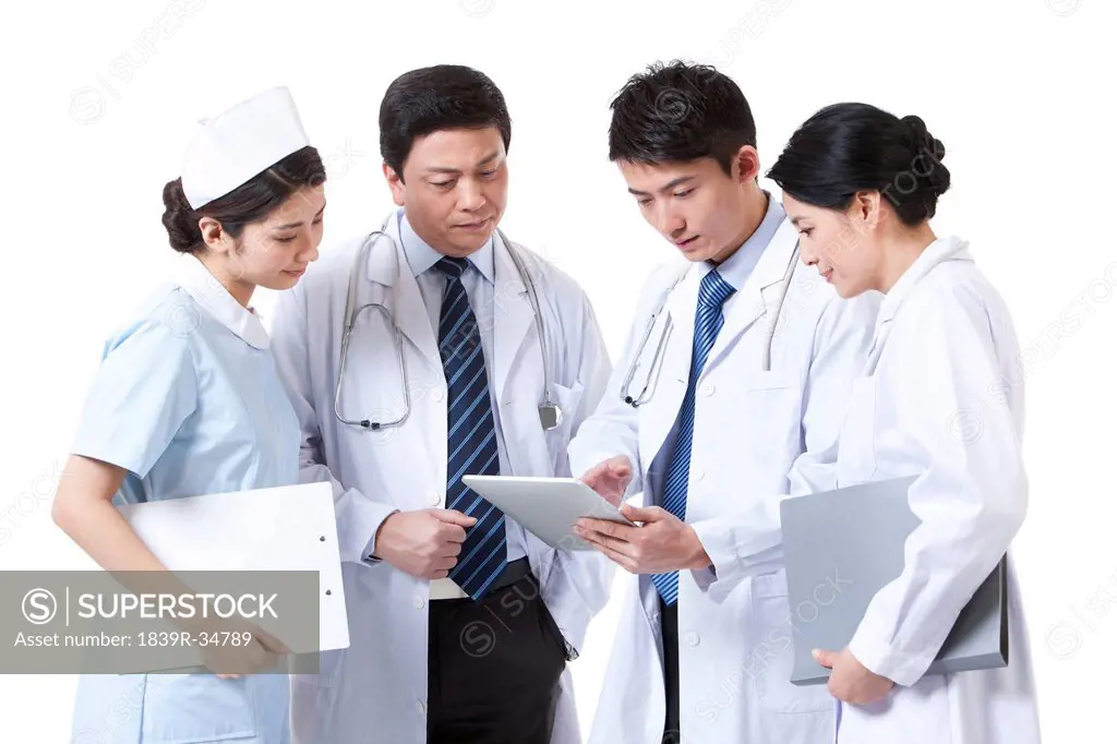 Professional medical team using digital tablet