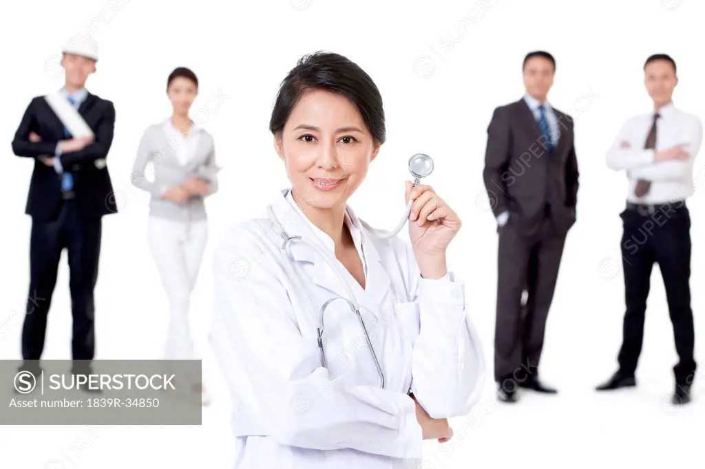 Professional female doctor with different occupation workers in background