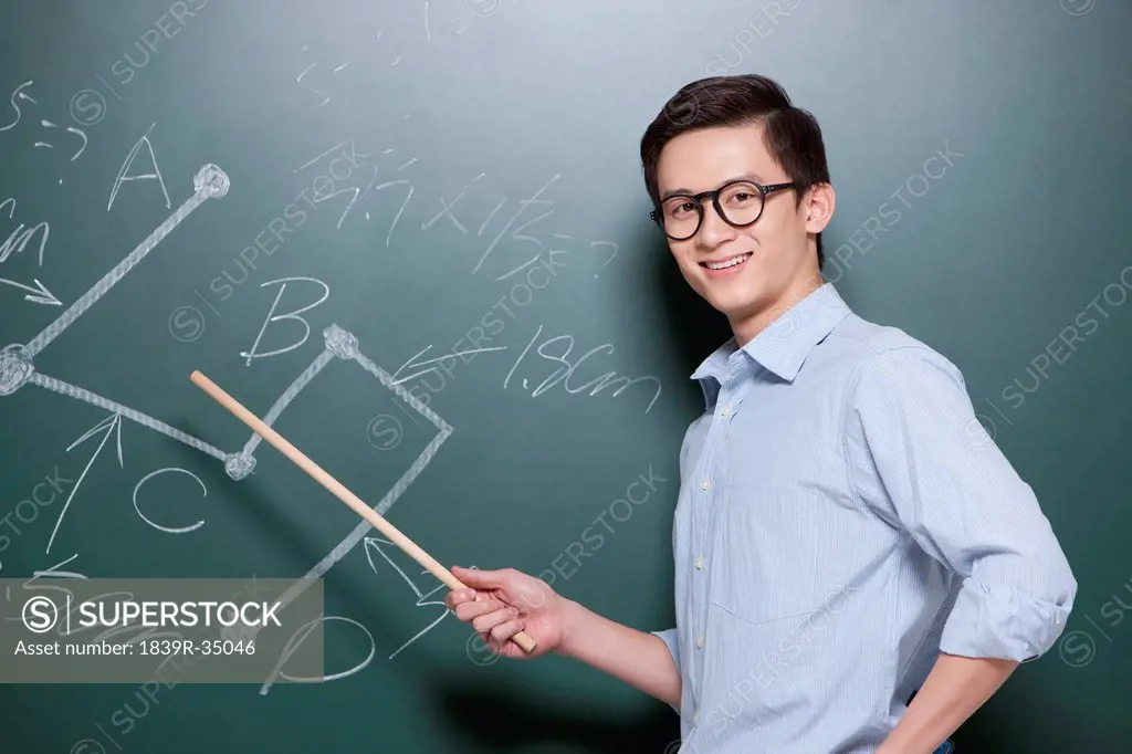 Confident Male teacher giving lessons in classroom