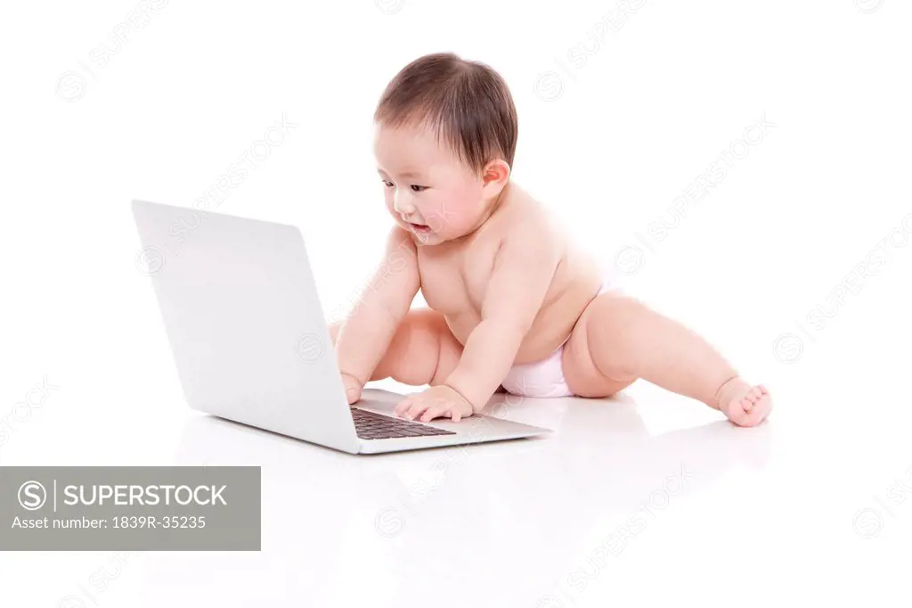 Cute baby girl with laptop