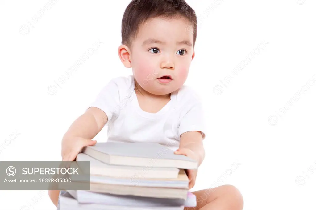 Cute baby boy with mortar board and glasses