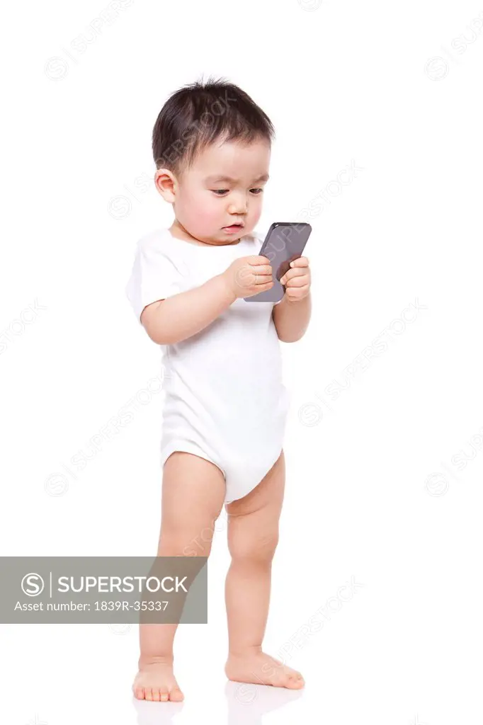 Adorable baby boy with smart phone