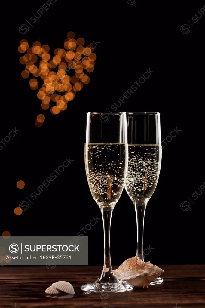 Champagne and heart-shaped glittering light