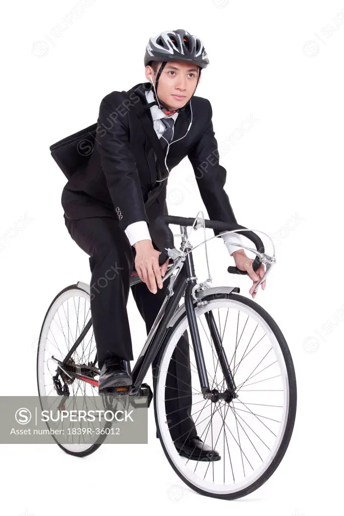 young businessman riding a bike