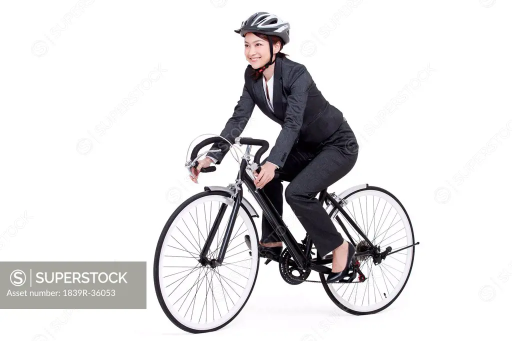 Young businesswoman on a bike