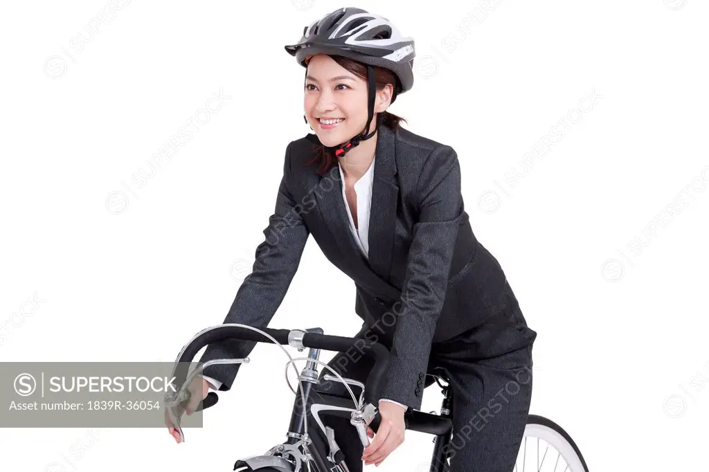 Young businesswoman on a bike