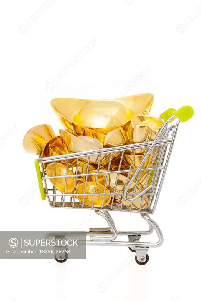 Chinese traditional currency gold yuanbao ingots in a small shopping cart