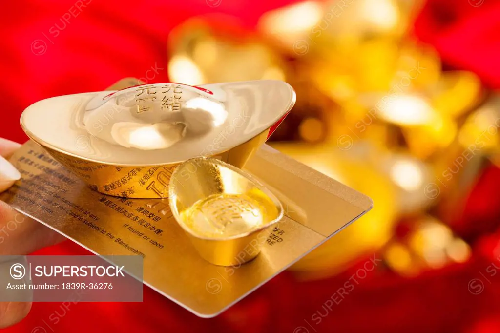 Chinese traditional currency gold yuanbao ingots and bank card