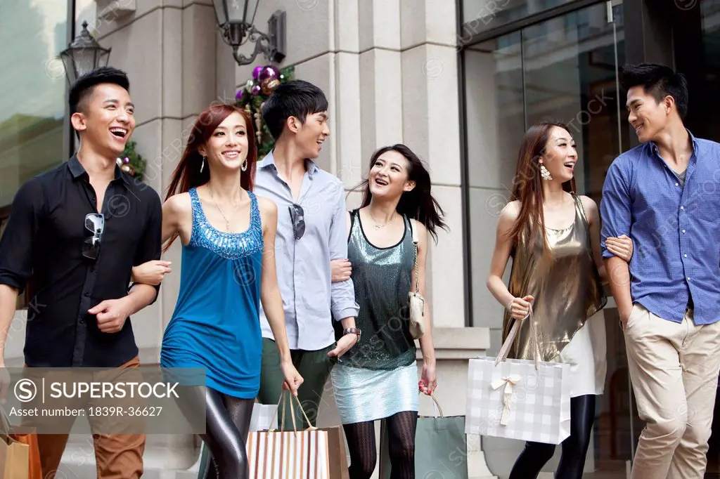 Excited young people go shopping on the street of Hong Kong