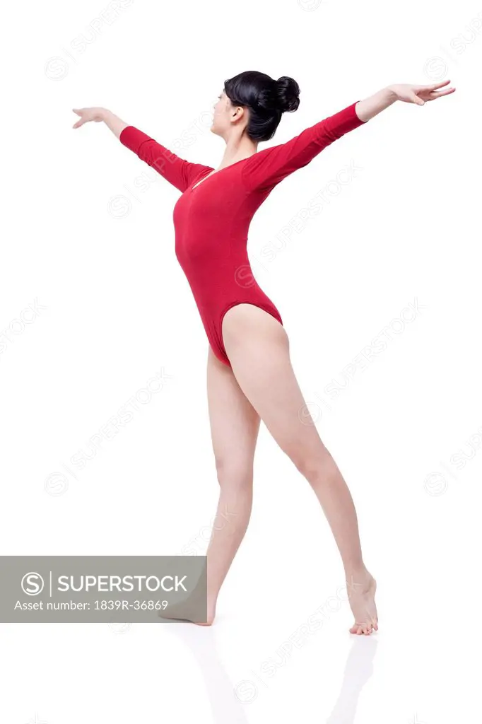 Female gymnast performing rhythmic gymnastics