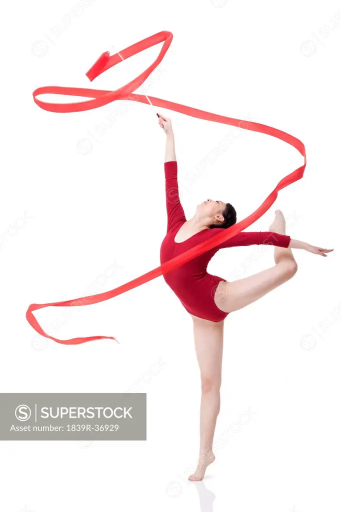 Female gymnast performing rhythmic gymnastics with ribbon
