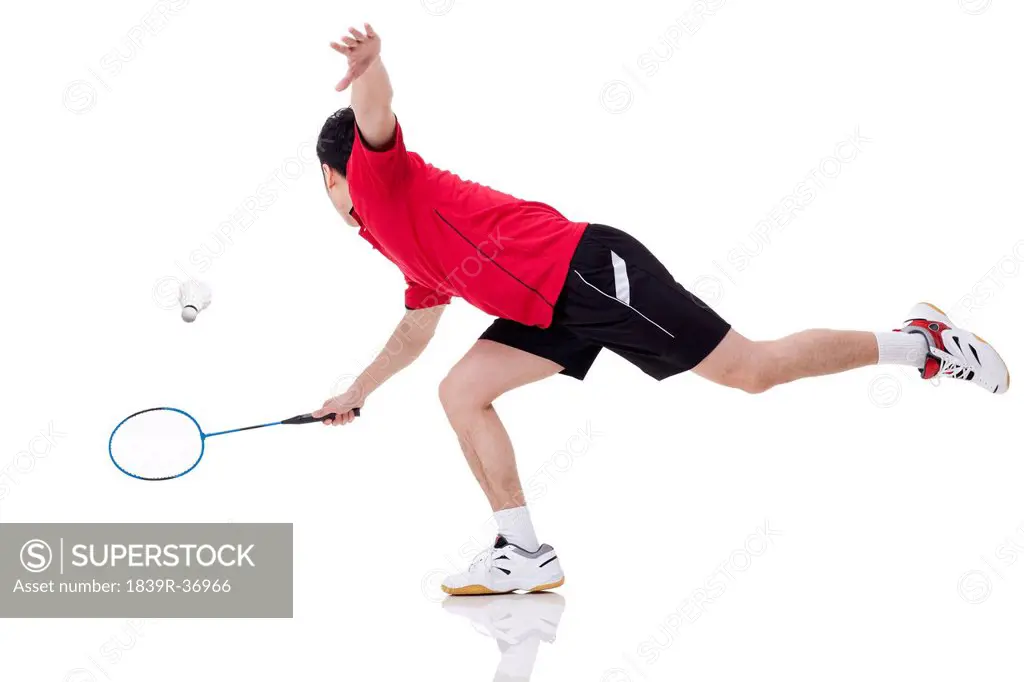 Male athlete playing badminton