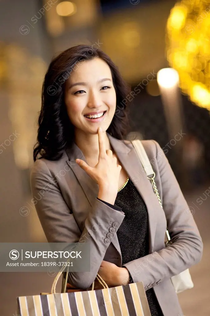 Cheerful young woman with shopping bags