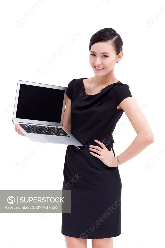 Fashionable businesswoman showing laptop