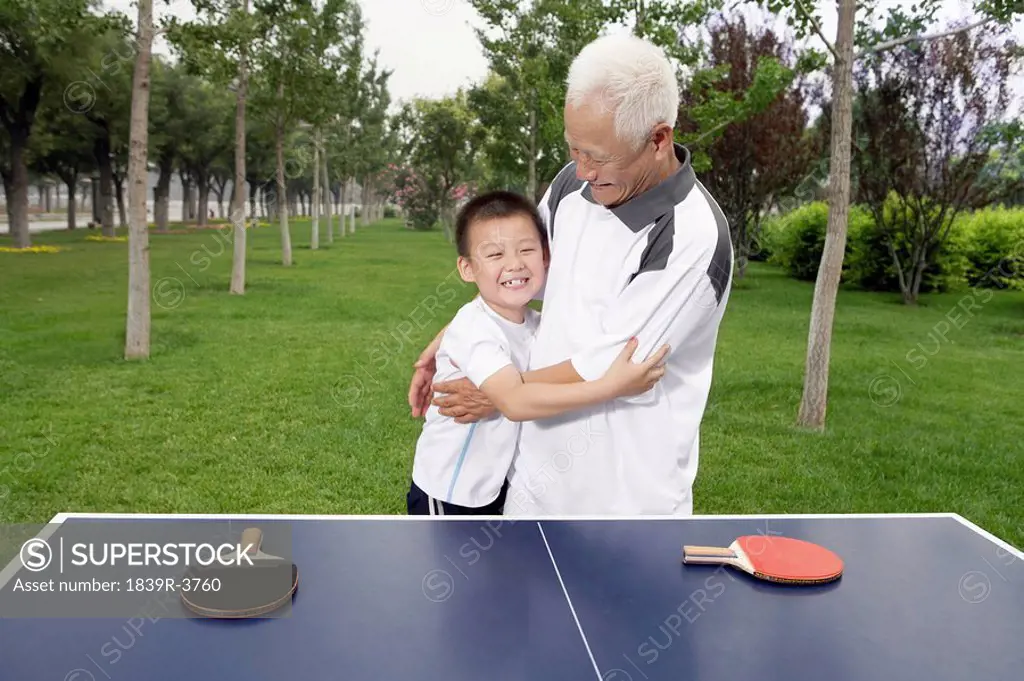 Grandfather And Grandson Playing Ping Pong