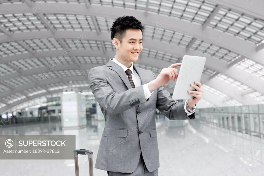 Young businessman with digital tablet at the airport
