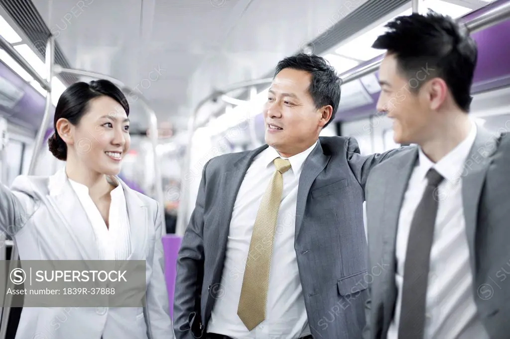 Cheerful business persons in subway train