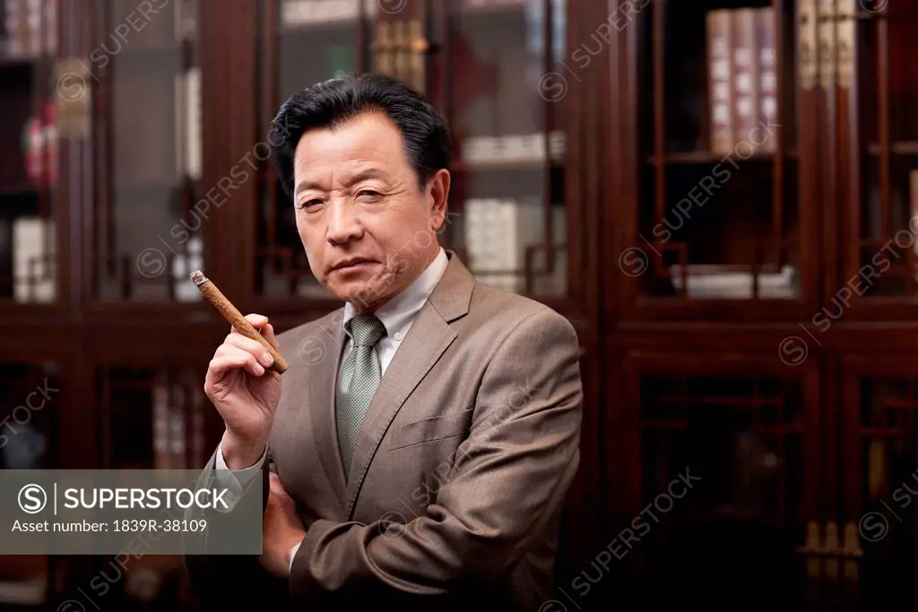 Successful businessman enjoying cigar