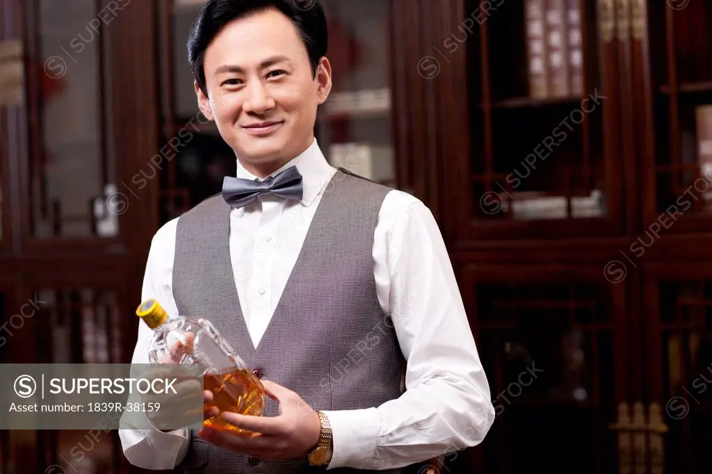 Wealthy businessman with wine bottle