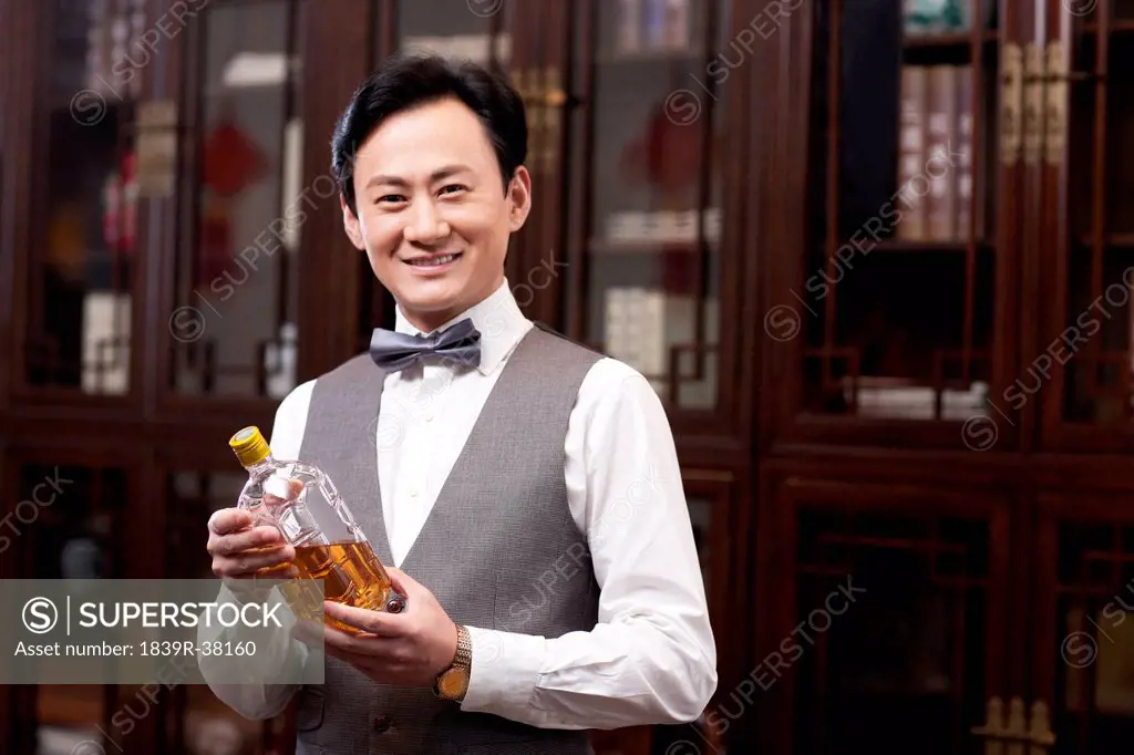 Wealthy businessman with wine bottle