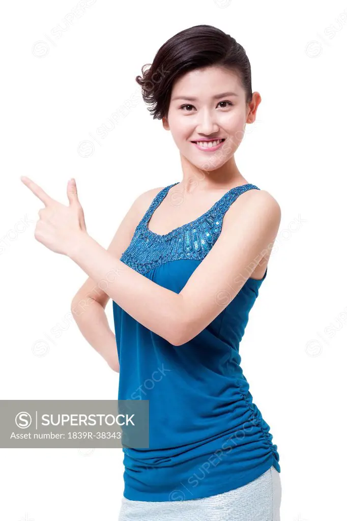 Cheerful young woman pointing