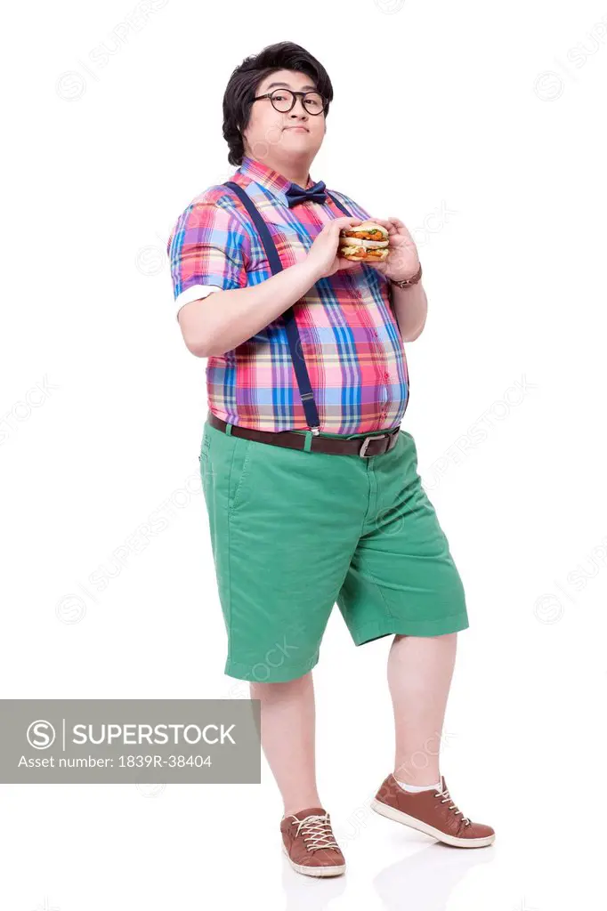 Happy overweight man with burger
