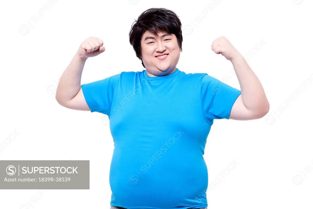 Cheerful overweight man showing power