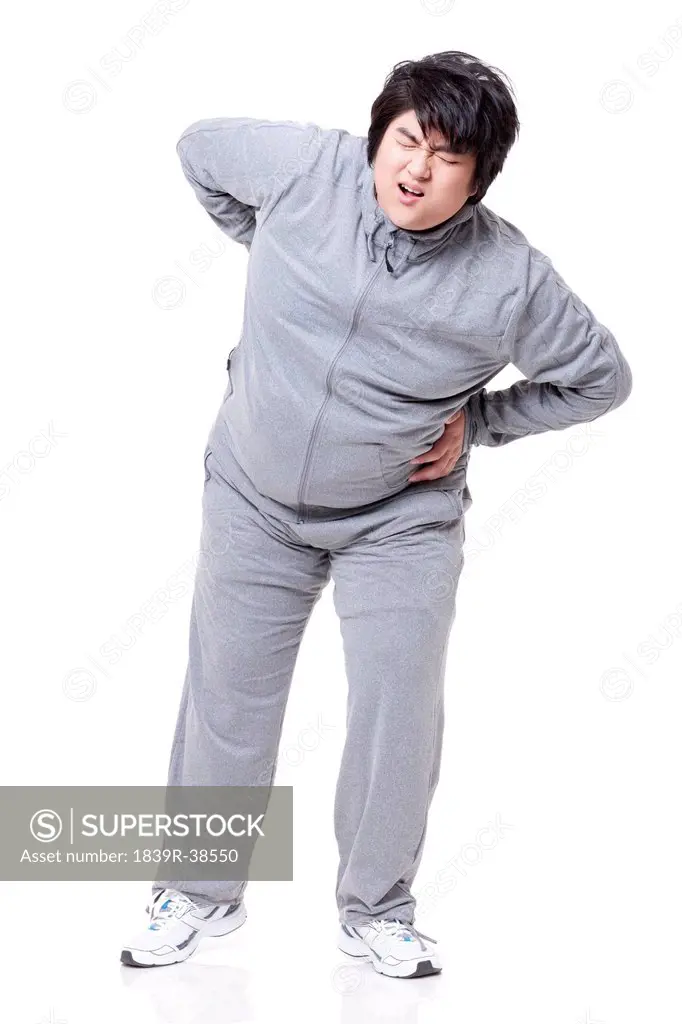 Overweight man suffering from backpain