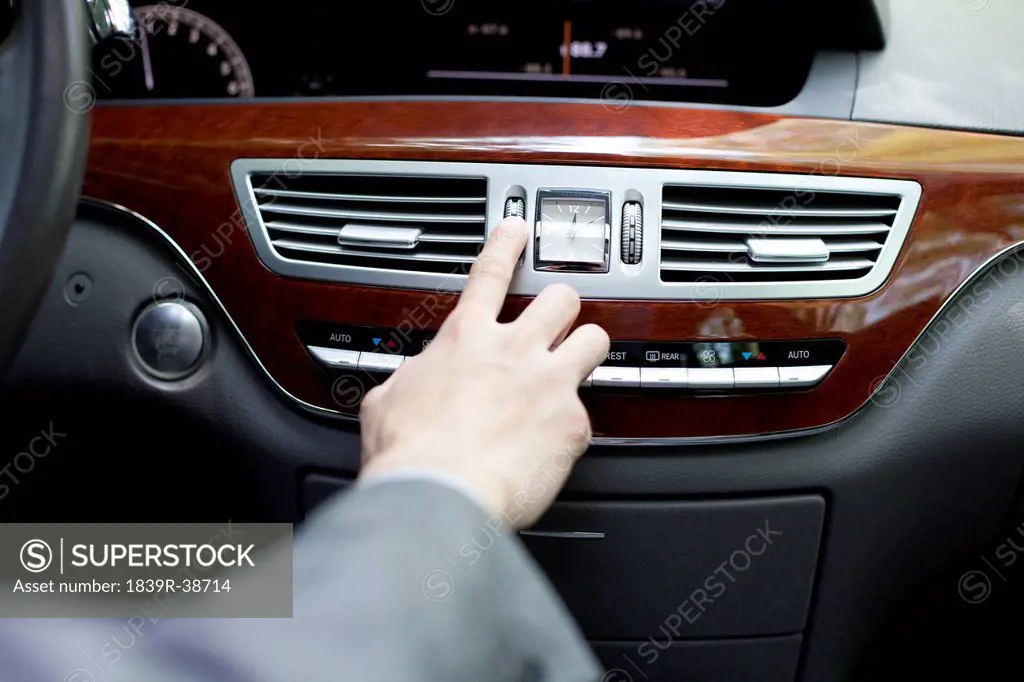 Driver adjusting car stereo