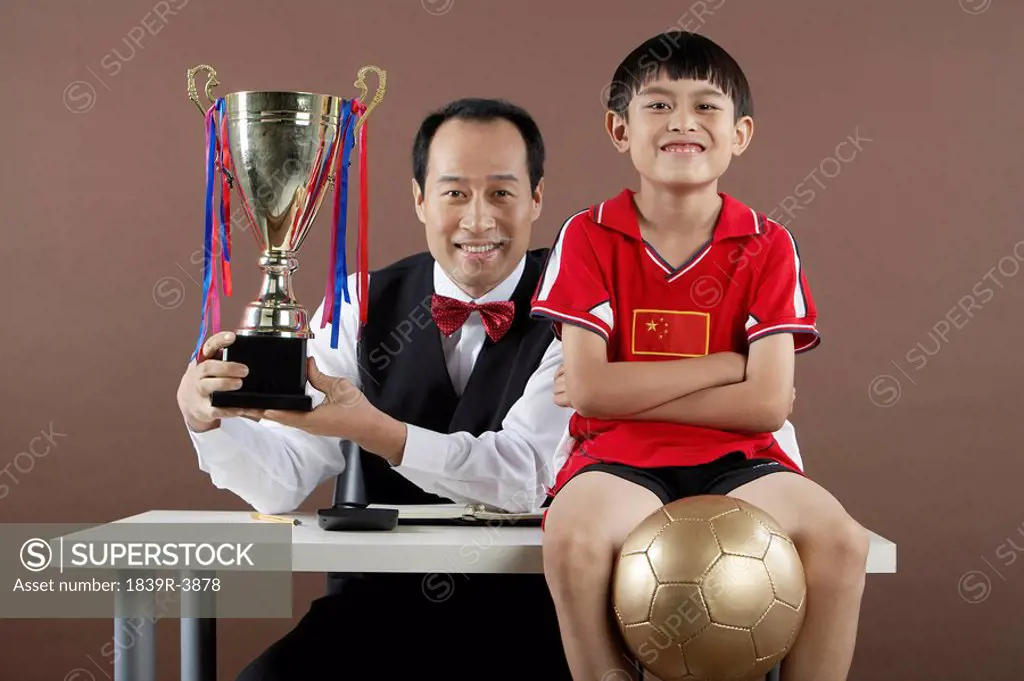 Father And Son Smiling, Father Holding Trophy