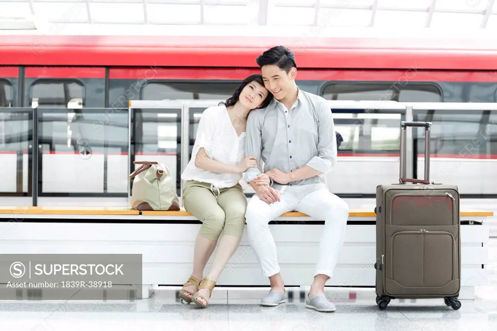Young couple resting at subway station