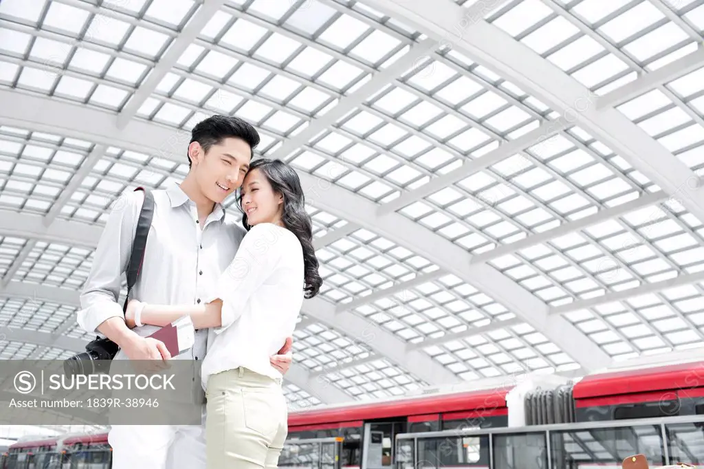 Young couple embracing at subway station