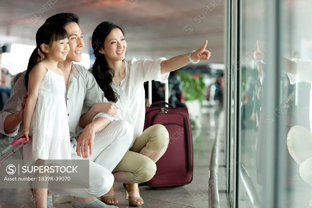 Young family looking at view at the airport