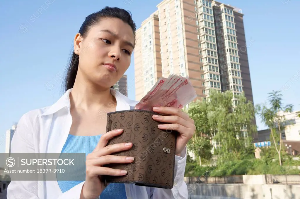 Woman In City Holding Wallet And Money