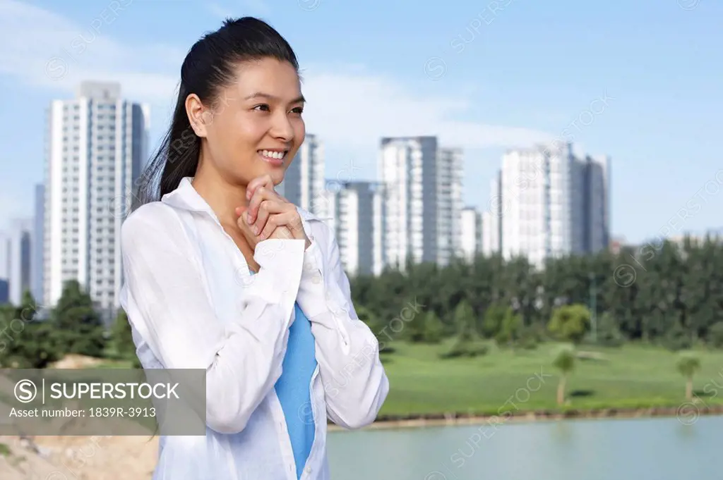Portrait Of Woman Smiling In Front Of A Cityscape