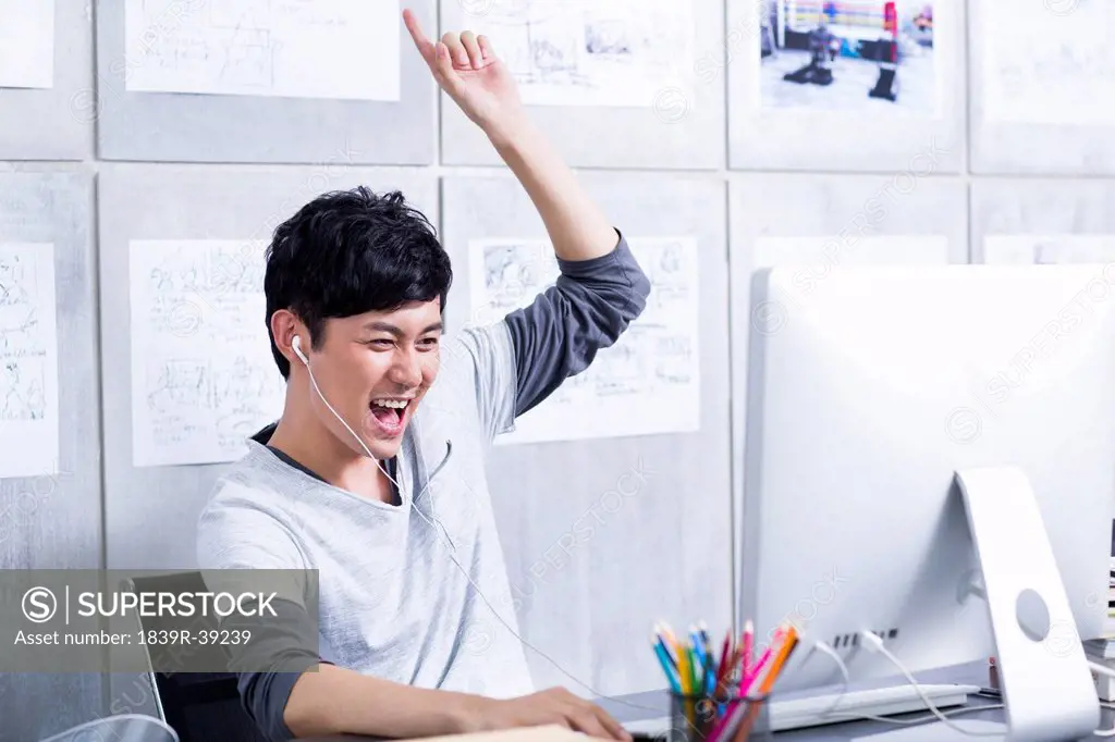 Cheerful young man having fun in the office