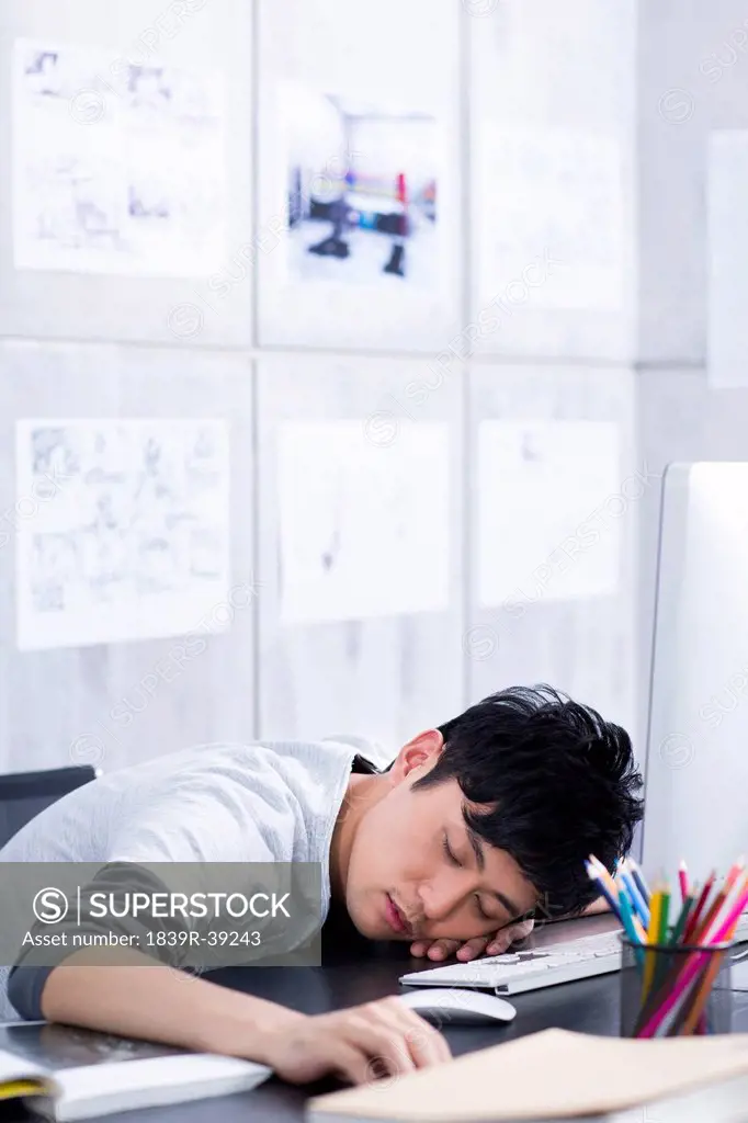 Young man taking a nap in the office
