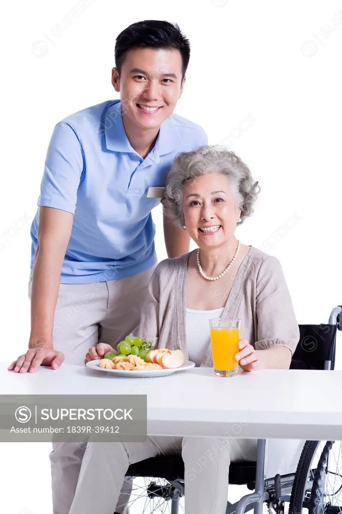 Disabled senior woman having breakfast in nursing home