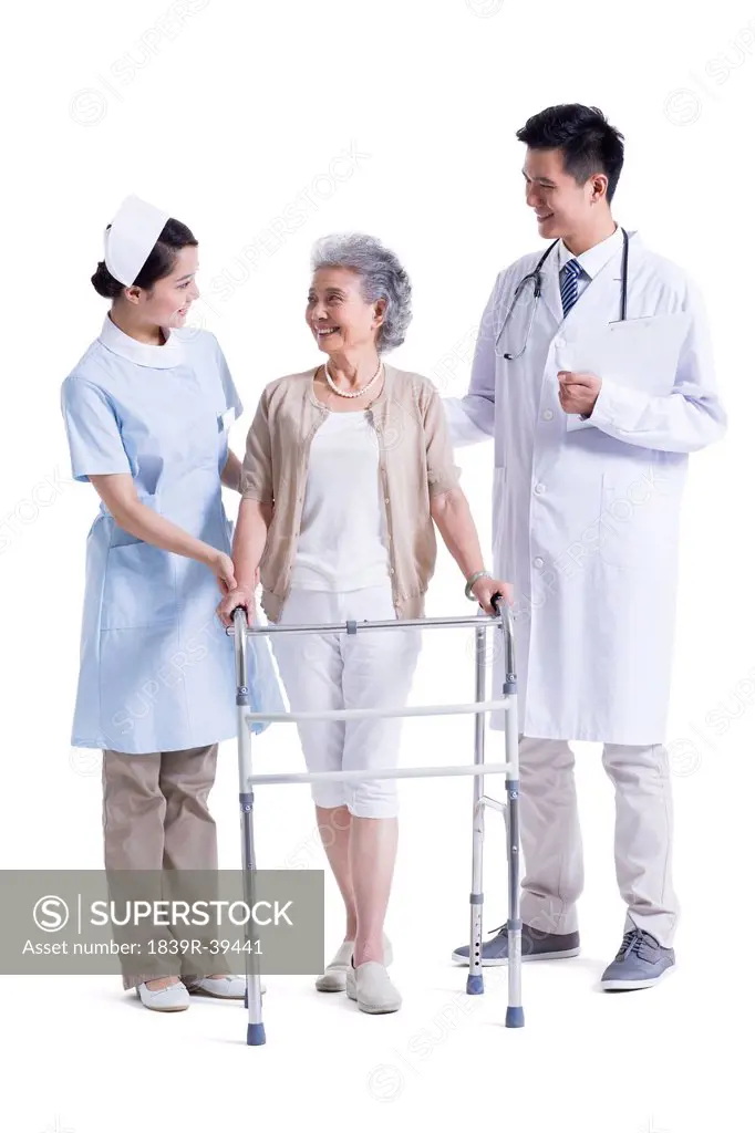 Doctor , nurse and patient with walking frame