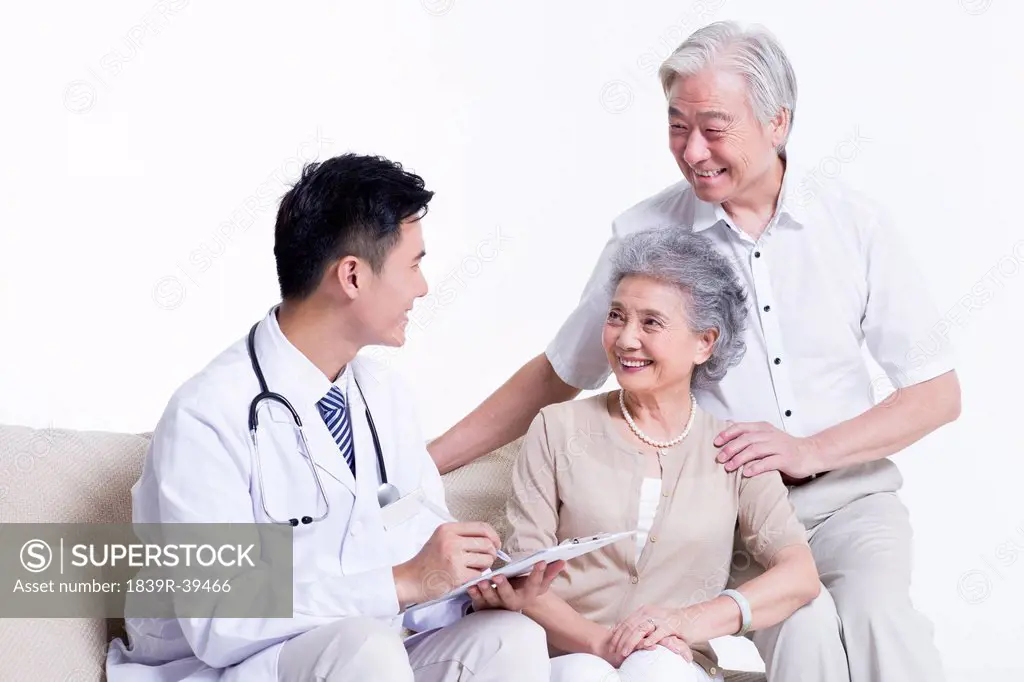 Doctor talking with senior couple
