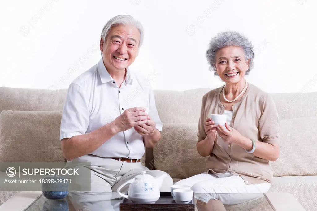 Cheerful senior couple having tea