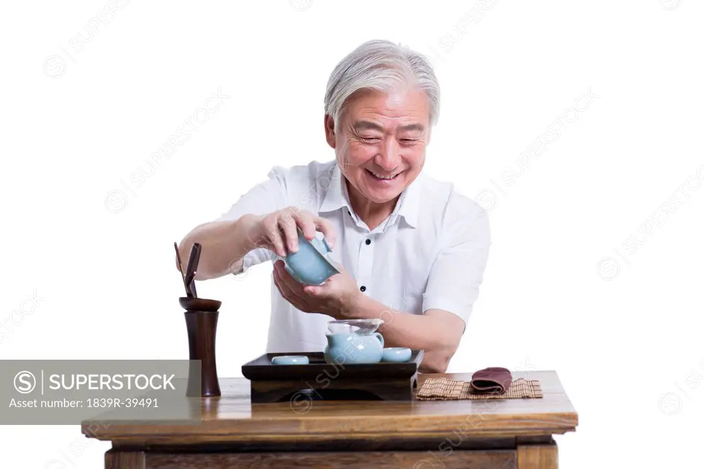 Happy senior man having tea