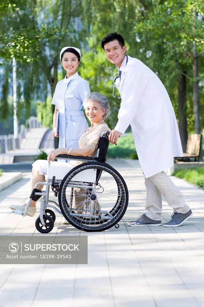 Doctor, nurse and wheelchair bound patient