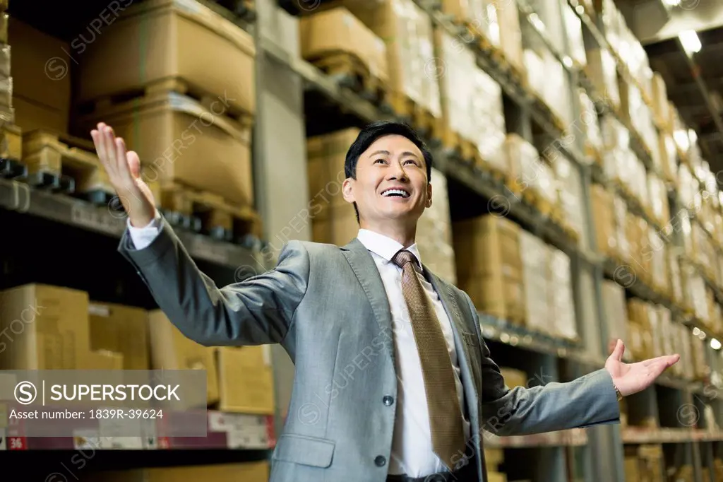 Cheerful businessman in warehouse