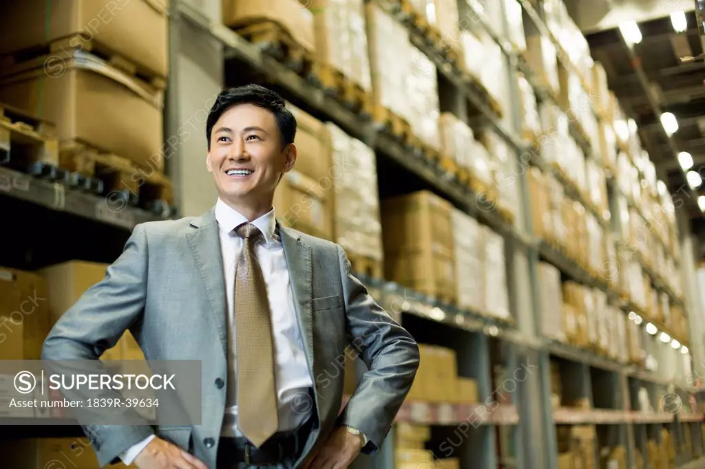 Confident businessman in warehouse