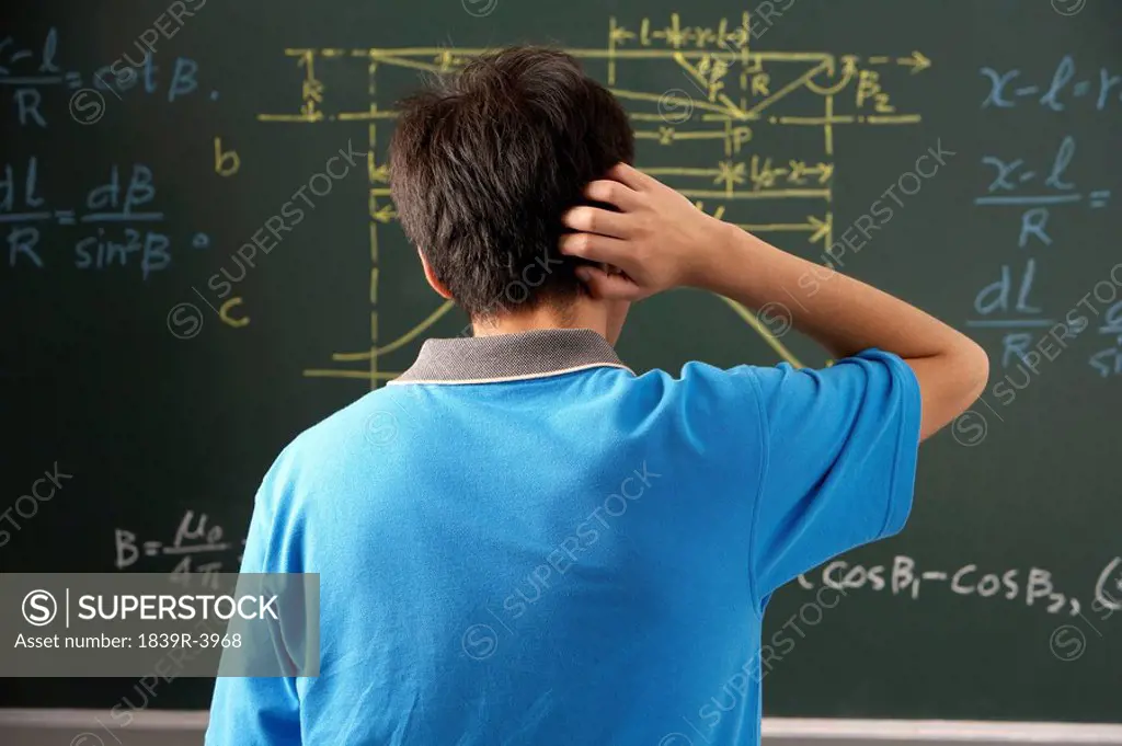 Student Looking At A Blackboard In A Classroom