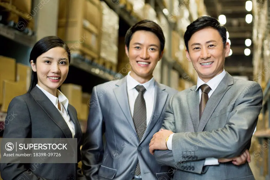Confident business people in warehouse