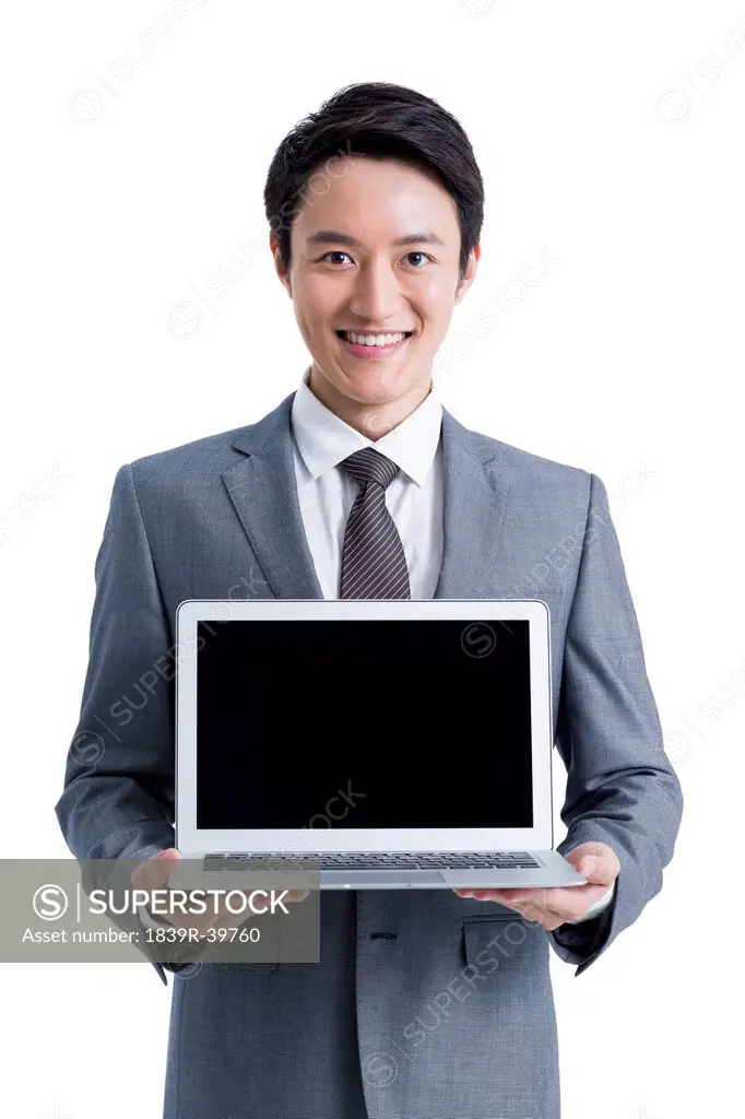 Young businessman presenting laptop
