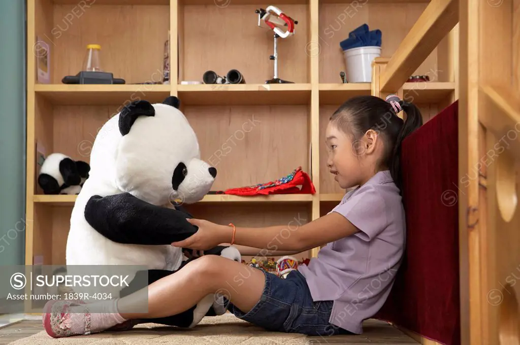 Young Girl Talking To A Stuffed Toy Panda