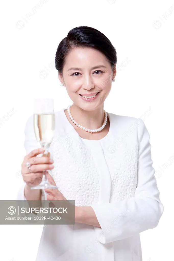 Elegant mature woman with champagne flute